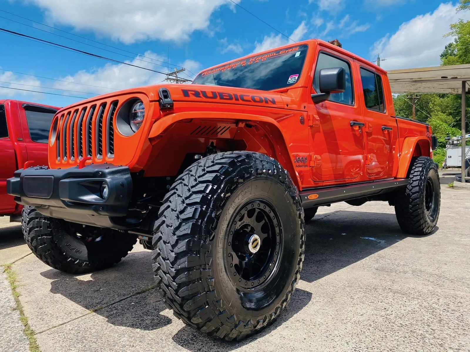 Orange lifted Jeep Gladiator after a professional full detail at Firestone Auto Detail in Gastonia, North Carolina