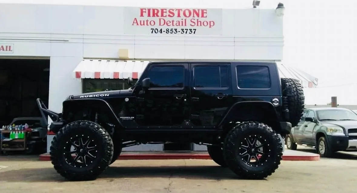Black lifted Jeep Wrangler after professional detailing at Firestone Auto Detail