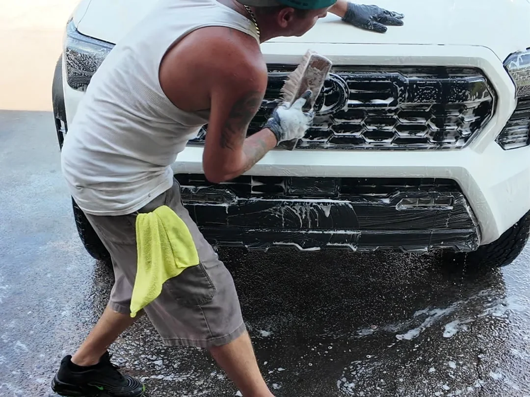 Donnie Ham washing a Toyota Tacoma during a full detail at Firestone Auto Detail